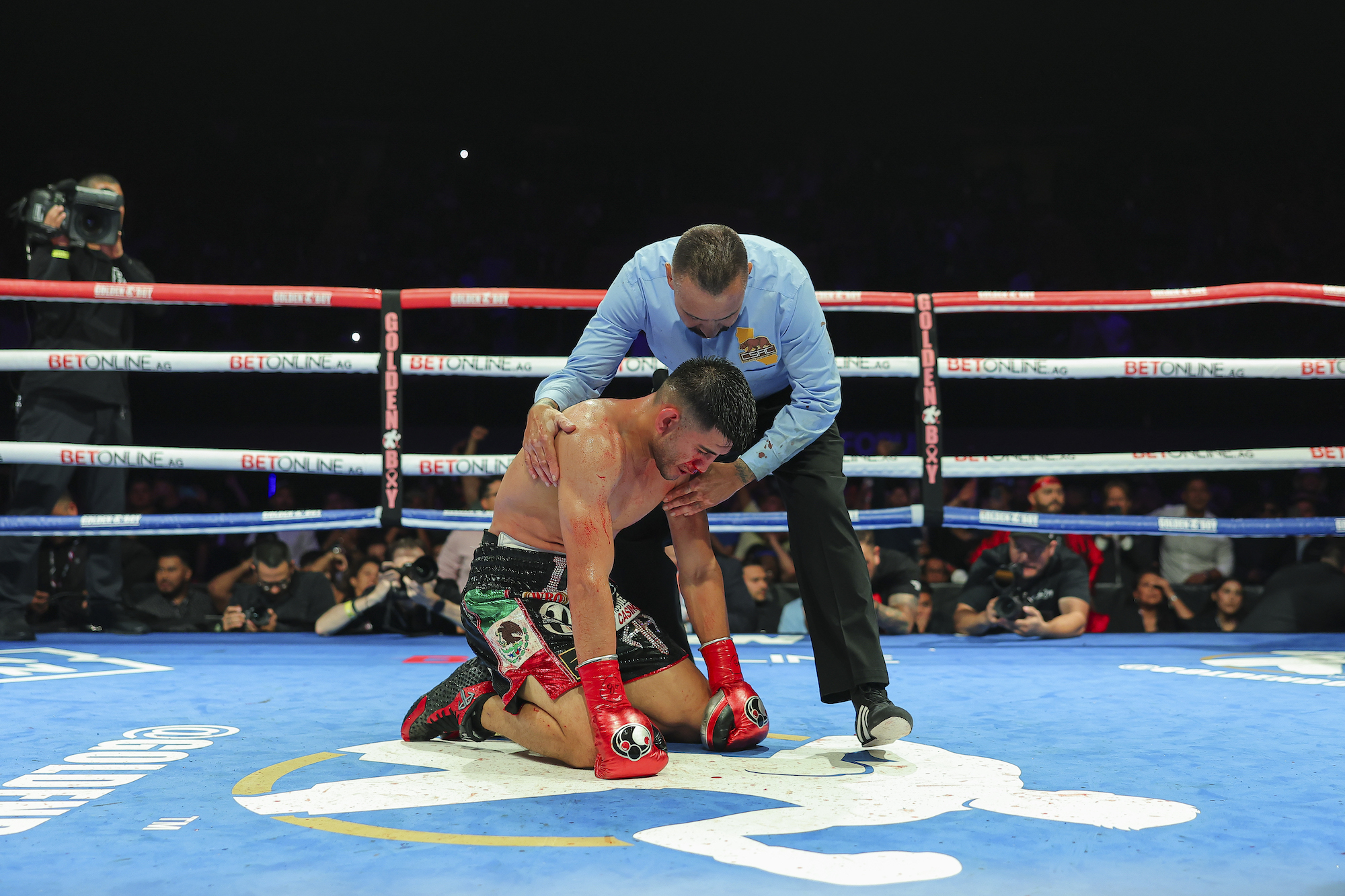 Alexis Rocha, bruised and beaten, blinked a tear from a swollen eye after his devastating loss to Giovani Santillan